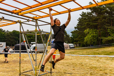 Poznan, Poland - June 2021: An hard extreme obstacle course Survival Race at rainy day