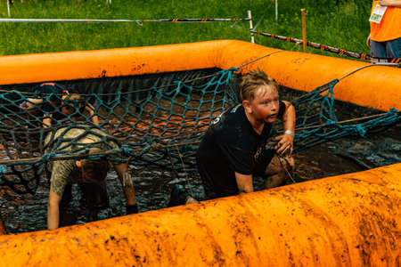 Poznan, Poland - June 2021: An hard extreme obstacle course Survival Race at rainy day