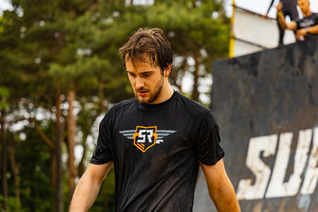 Poznan, Poland - June 2021: An hard extreme obstacle course Survival Race at rainy day