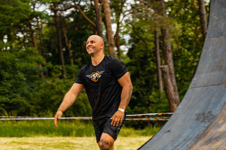 Poznan, Poland - June 2021: An hard extreme obstacle course Survival Race at rainy day