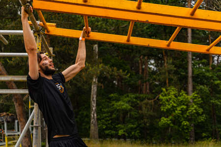 Poznan, Poland - June 2021: An hard extreme obstacle course Survival Race at rainy day