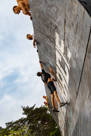 Poznan, Poland - June 2021: An hard extreme obstacle course Survival Race at rainy day