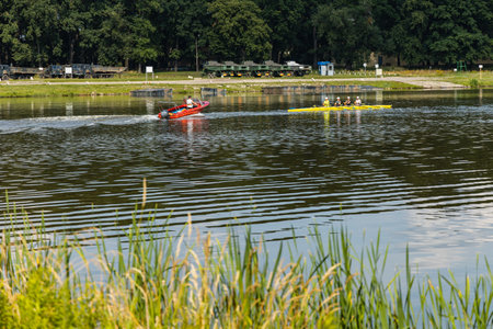Wroclaw, Poland - July 15 2021: Man swimming on small boat and group of people swimming on kayak on...
