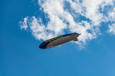 Wroclaw, Poland - July 31 2021: Big airship with Goodyear logo flying over market square at sunny cloudy dayのeditorial素材