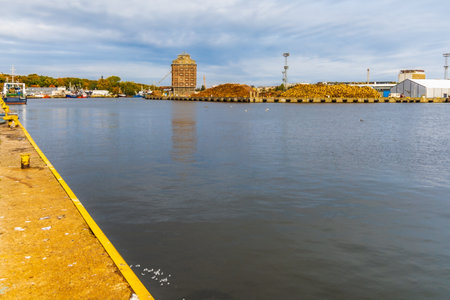 Kolobrzeg, Poland - October 2021: View from old marina to stacks of cutted wood in other side of marinaのeditorial素材