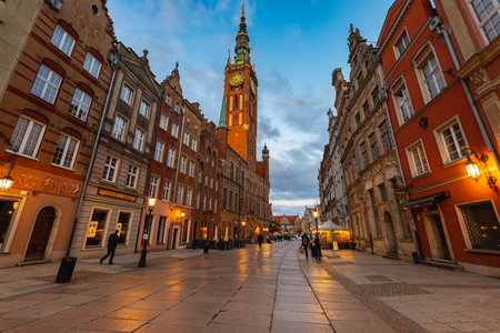Gdansk, Poland - April 2022: Dluga street full of small shops and restaurants next to market square and beautiful town hallのeditorial素材