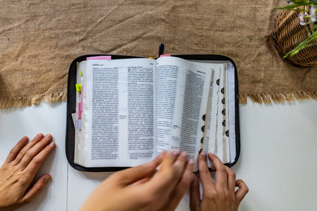 Reading Holy Bible with colorful highlights on pages which is lie on wooden tableの写真素材