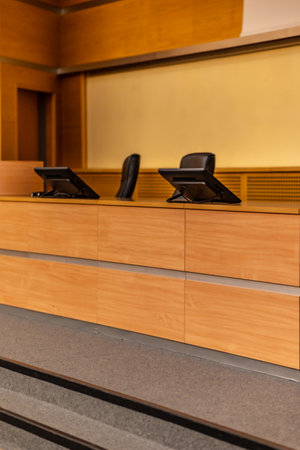 Interior of big conference hall full of gray folding chairs and wooden wallsの写真素材