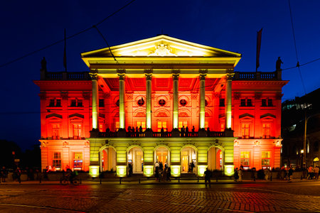 Wroclaw, Poland - June 2022: Wroclaw Opera House illuminated with colored lights in yellow and red on a dark summer eveningのeditorial素材