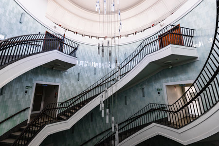Poznan, Poland - July 2022: The interior of the Okraglak business center with a beautiful and large spiral staircaseのeditorial素材