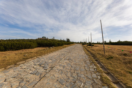 Long and stony mountain trail on a sunny autumn dayの写真素材