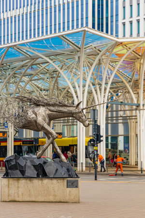 Lodz, Poland - April 20 2023: Steel sculpture of a unicorn half melting in the air by Tomohiro Inaba at city center next to colorful tram station named unicorn stableのeditorial素材