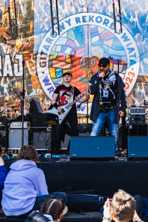 Wroclaw, Poland - May 1 2023: Artists and guitarists at main stage at open event Guitar Guinness World Record 2023 where record was beaten with 7967 guitars at market squareのeditorial素材