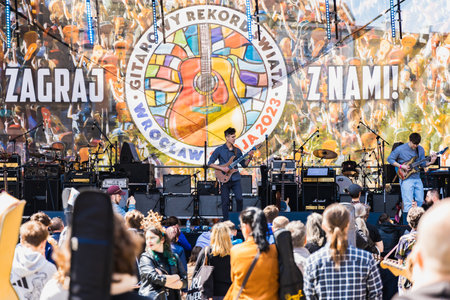 Wroclaw, Poland - May 1 2023: Artists and guitarists at main stage at open event Guitar Guinness World Record 2023 where record was beaten with 7967 guitars at market squareのeditorial素材