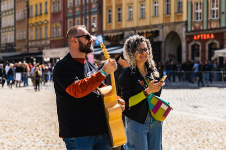 Wroclaw, Poland - May 1 2023: Participants with guitars at open event Guitar Guinness World Record 2023 where record was beaten with 7967 guitars at market squareのeditorial素材