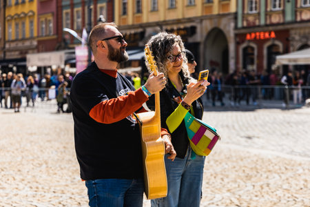 Wroclaw, Poland - May 1 2023: Participants with guitars at open event Guitar Guinness World Record 2023 where record was beaten with 7967 guitars at market squareのeditorial素材
