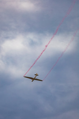 Leszno, Poland - June 16 2023: Antidotum Airshow Leszno 2023 and acrobatic shows of DFS Habicht sky glider with smoke show at cloudy skyのeditorial素材