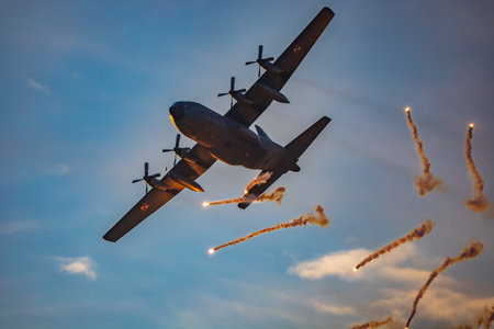 Leszno, Poland - June 16 2023: Antidotum Airshow Leszno 2023 and acrobatic shows full of smoke of C-130 Hercules plane on a cloudy skyのeditorial素材