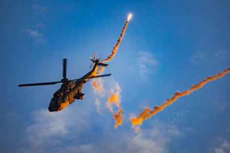 Leszno, Poland - June 16 2023: Antidotum Airshow Leszno 2023 and acrobatic shows full of smoke of Super Puma Display Team helicopter on a cloudy skyのeditorial素材