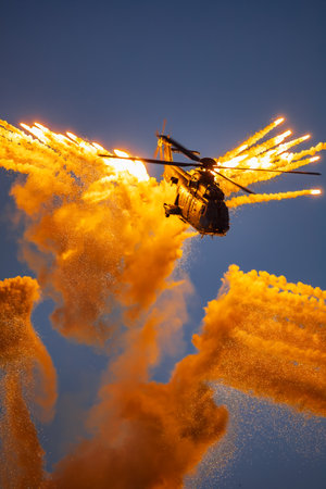 Leszno, Poland - June 16 2023: Antidotum Airshow Leszno 2023 and acrobatic shows full of smoke of Super Puma Display Team helicopter on a cloudy skyのeditorial素材