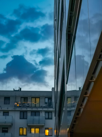 Wroclaw, Poland - June 20 2023: Facade of modern block of flat full of modern apartments at cloudy afternoon reflected in facade of balconyのeditorial素材