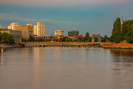 Wroclaw, Poland - June 25 2023: Beautiful and colorful cityscape of old city and promenade in Wroclaw city over the Odra river at beautiful golden hour at sunsetのeditorial素材