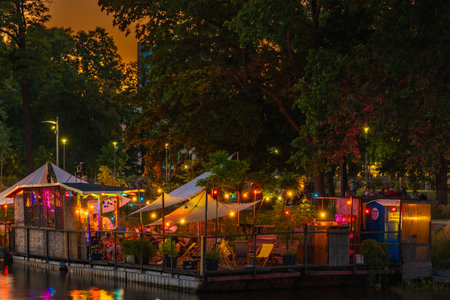 Wroclaw, Poland - June 25 2023: Facades of modern bars and restaurants on water by the isle and full of tiny glowing lights aroundのeditorial素材