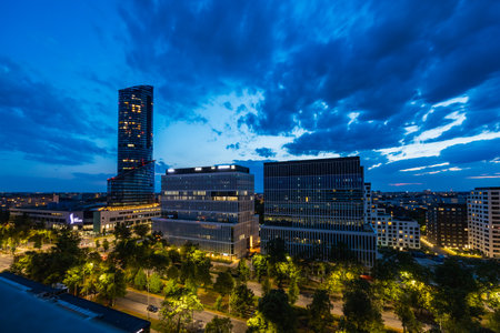 Wroclaw, Poland - July 17 2023: Beautiful cityscape of Gwiazdzista south center with corporate and residential buildings with Sky Tower skyscraper next to it seen from high block of flat at blue hourのeditorial素材
