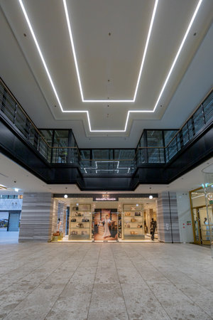 Wroclaw, Poland - July 14 2023: Interiors of beautifully renovated in modern and exclusive style old shopping mall full of marble and lights at city centerのeditorial素材