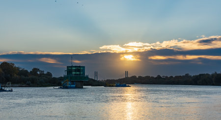 Warsaw, Poland - October 15 2023: Beautiful cloudy sunrise with golden clouds and rising sun over...
