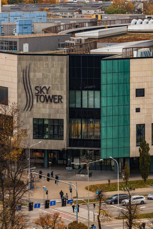 Wroclaw, Poland - November 12 2023: Facade of entrance to Sky Tower shopping mall inside of the tallest skyscraper in Wroclaw city next to intersection and walking people on the crossingのeditorial素材