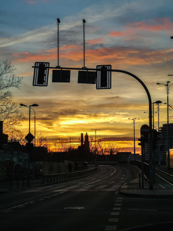 Wroclaw, Poland - December 19 2023: Beautiful and colorful morning cloudy sunrise with shining sun over city streets and buildingsのeditorial素材