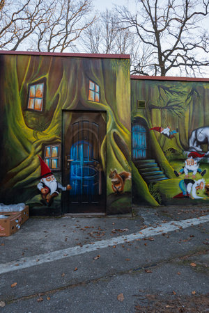 Sobotka, Poland - January 29 2024: Beautiful and colorful fantasy painting with dwarfs and forest on facade walls of brewery building and rope park Wiezycaのeditorial素材