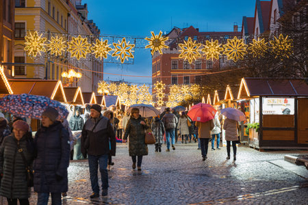 Wroclaw, Poland - January 6 2025: Festive Christmas Market in Wroclaw Poland with Traditional Wooden Stalls and Holiday Lights in the Historic Old Town Squareのeditorial素材