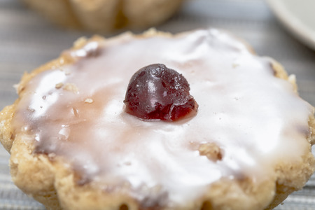 Marzipan cake with sugar glaze and candied cherryの写真素材
