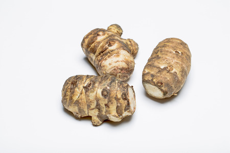 Jerusalem artichoke tubers on a white background