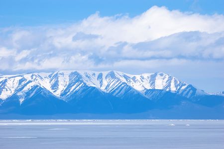 blue mountains under clouds at winter Baikalの写真素材