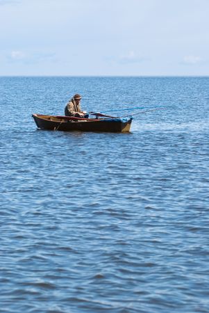 fisher with rods in boat at Baikalの写真素材