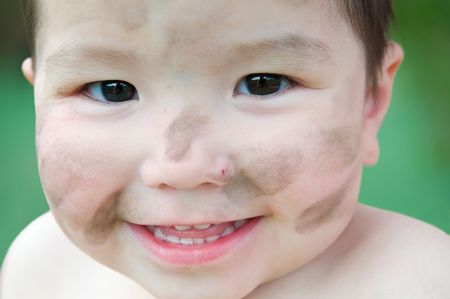 face of smiling child looking into cameraの写真素材