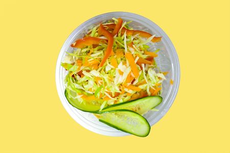cabbage carrot salad isolated on yellow backgroundの写真素材