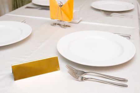 laid table at restaurant with golden plate to add any text thereの写真素材