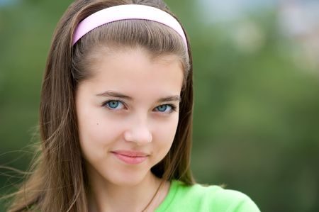 young beautiful european girl looks playfully into cameraの写真素材