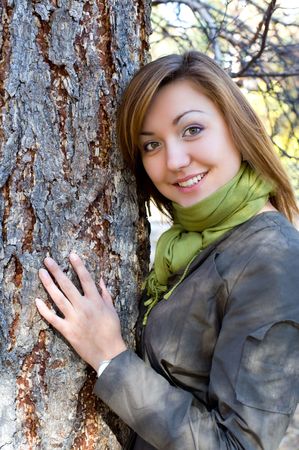 young beautiful european girl by a treeの写真素材