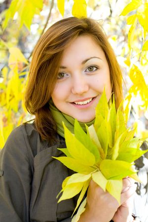 young beautiful european girl in autumn forestの写真素材