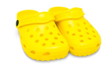 yellow childrens rubber sandals isolated on white with clipping pathの写真素材