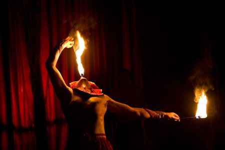 ULAN-UDE, RUSSIA - JUNE 26: A circus artist performs a number with fire on JUNE 26, 2009 in Ulan-Ude, Buryatia, Russia.の写真素材