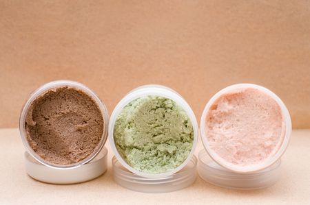 some plastic jars with coloured saline body scrubの写真素材