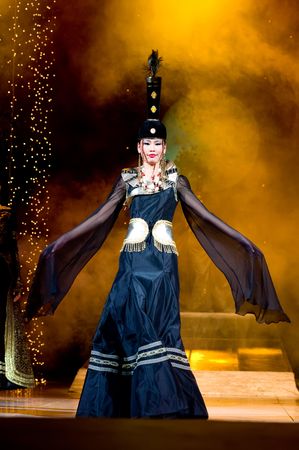 ULAN-UDE, RUSSIA - OCTOBER 29: An asian model demonstrates a dress in ethnic style at the international asian fashion festival on October, 29, 2009 in Ulan-Ude, Buryatia, Russia.のeditorial素材