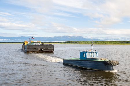 tug boat tows a car ferry at Baikalの写真素材