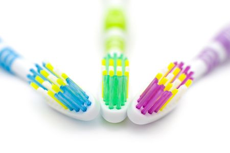 three coloured toothbrushes in a macro shotの写真素材
